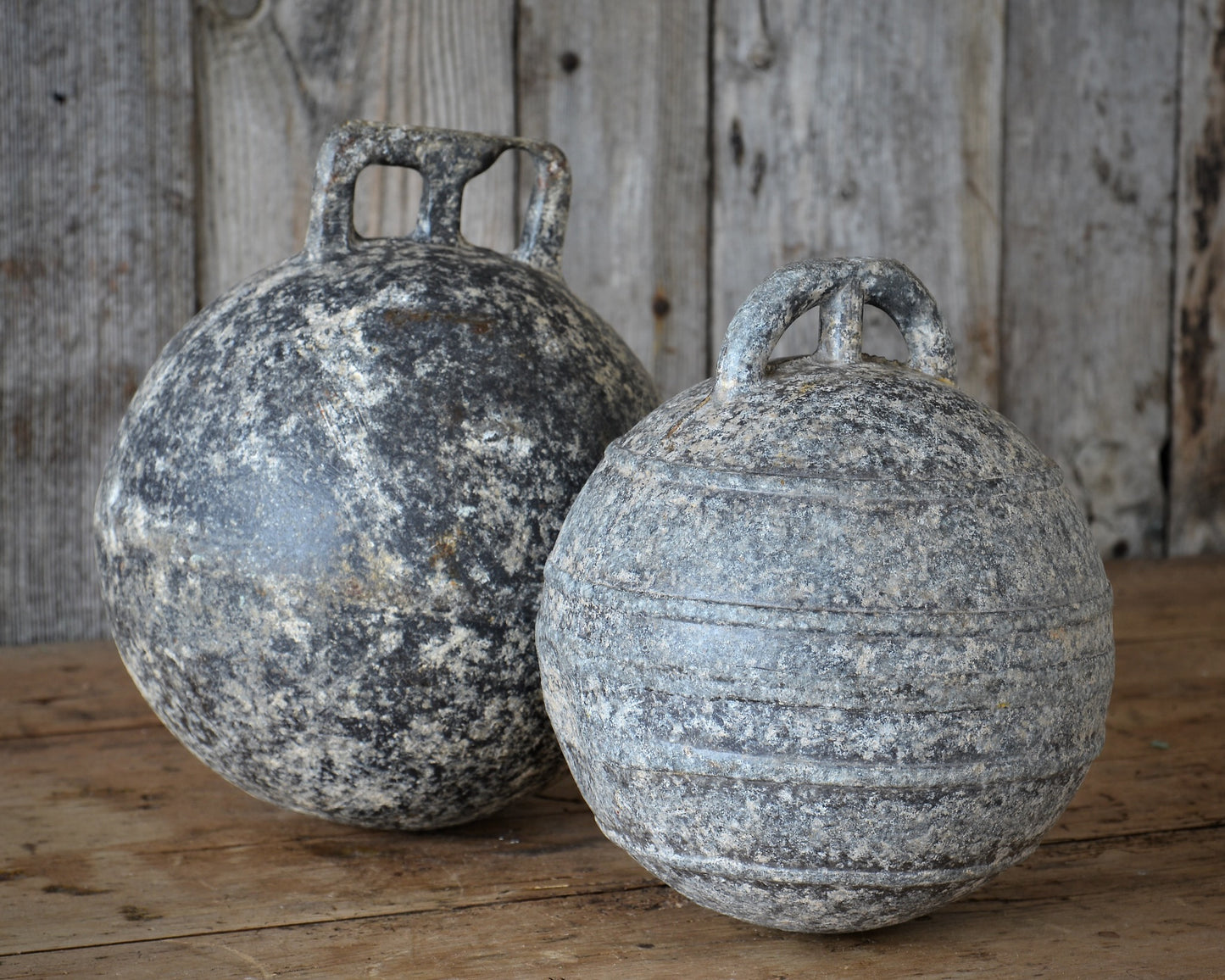 Two vintage aluminium fishing floats.